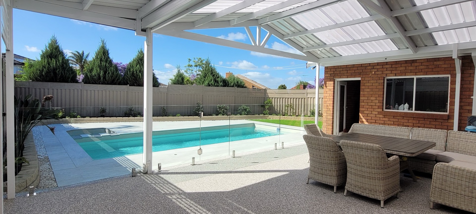Wide view of a completed patio and pergola area