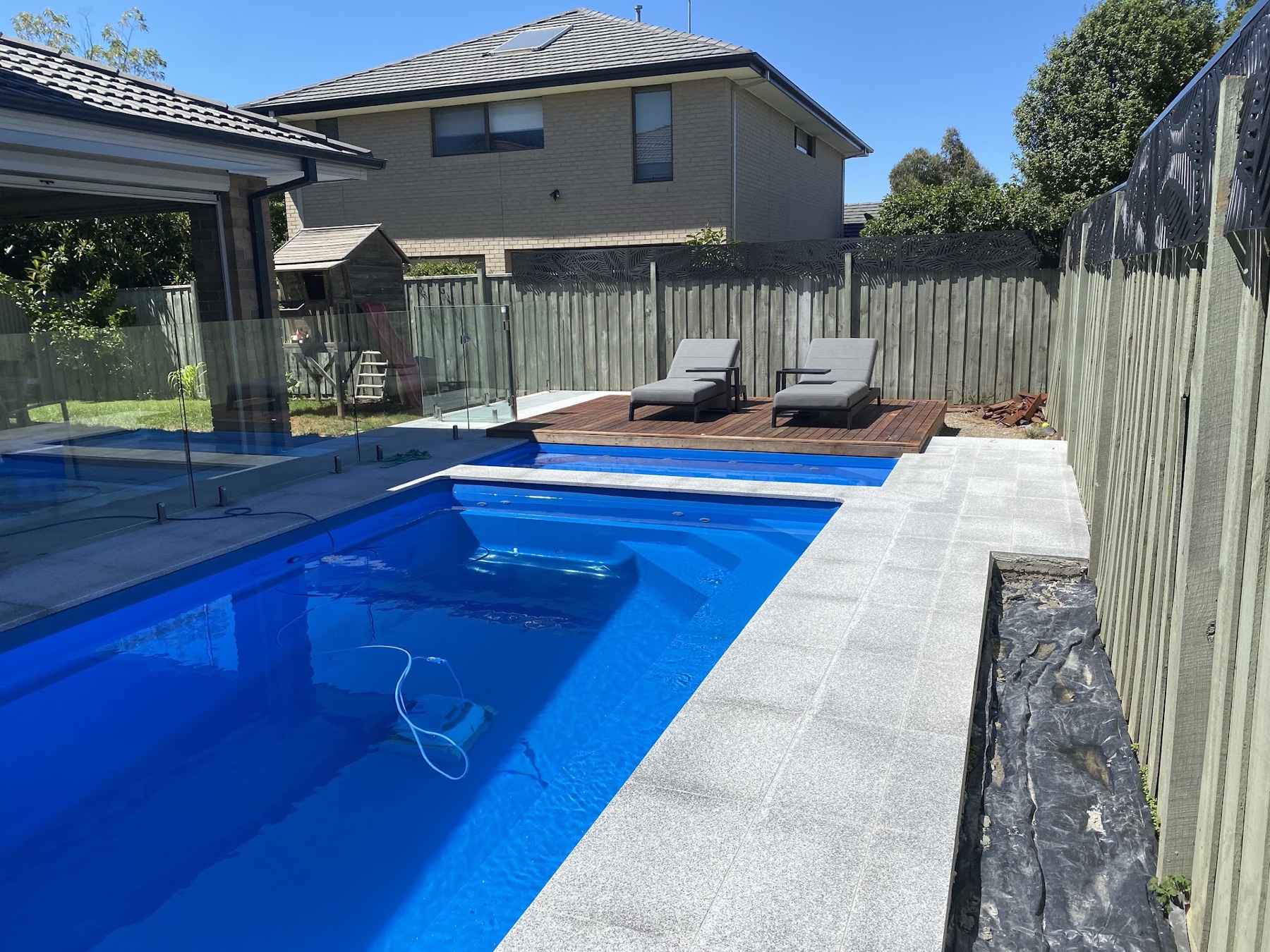Granite pool deck with a clean concrete edge